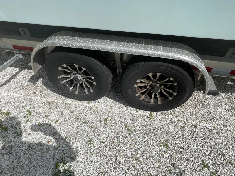 Slide: The Image of Parker 25SE 2022 trailer with dual wheels on gravel. - 15