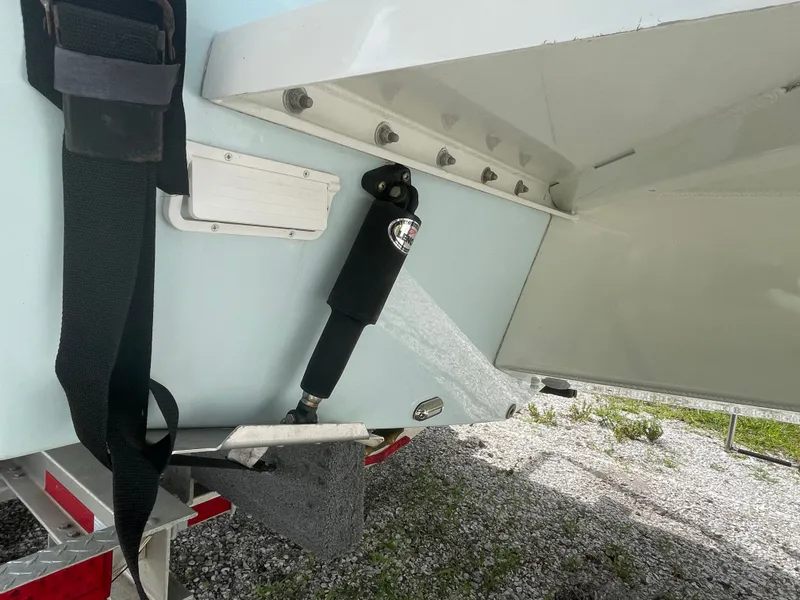 Slide: The Image of Rear view of a 2022 Parker 25SE boat on a trailer. - 25