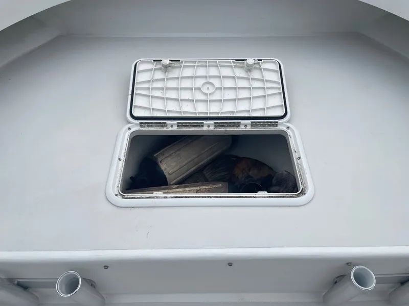 Slide: The Image of Open storage compartment on a 2022 Parker 25SE boat. - 33