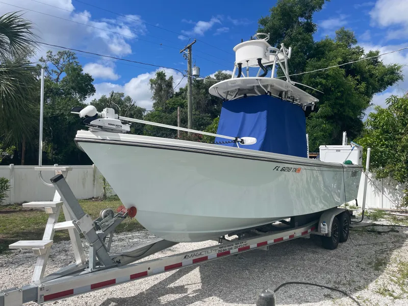 Slide: The Image of Parker 25SE boat 2022 on trailer, blue sky, green trees. - 7