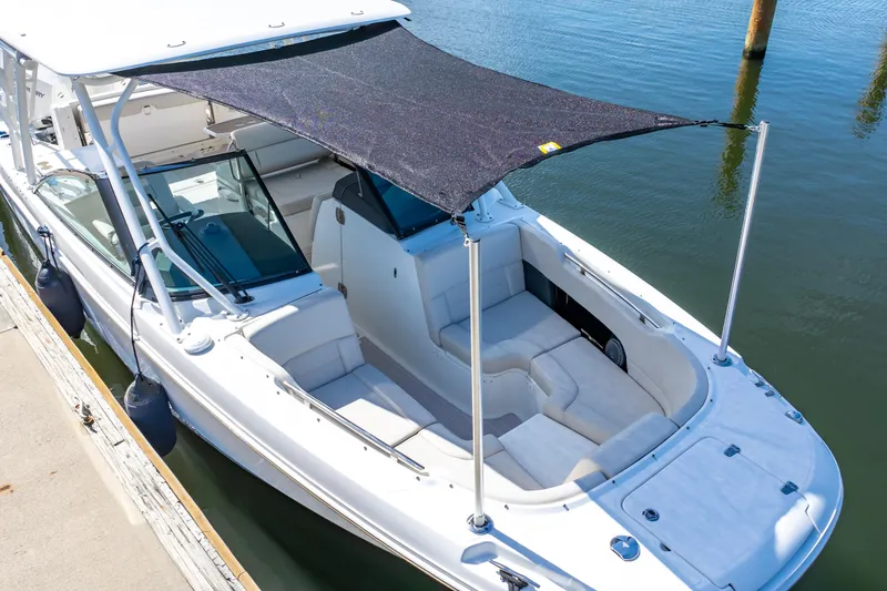Slide: The Image of 2019 Boston Whaler 270 Vantage boat with sunshade docked at marina. - 15