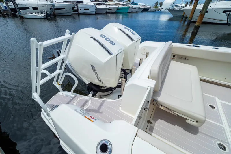 Slide: The Image of 2019 Boston Whaler 270 Vantage boat with dual Mercury engines docked at marina. - 19