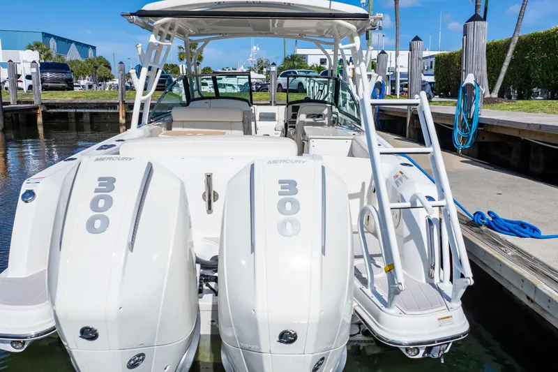 Slide: The Image of 2019 Boston Whaler 270 Vantage with twin Mercury 300 engines docked at marina. - 20