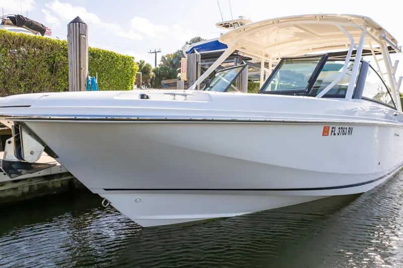 Slide: The Image of 2019 Boston Whaler 270 Vantage boat docked in sunny marina setting. - 24