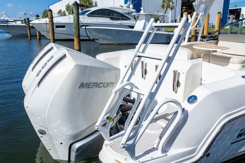 Slide: The Image of 2019 Boston Whaler 270 Vantage with Mercury outboard engines docked at marina. - 25