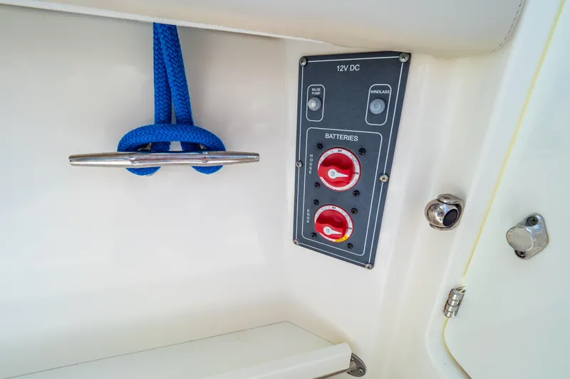Slide: The Image of Battery control panel and cleat with blue rope on 2019 Boston Whaler 270 Vantage boat. - 29