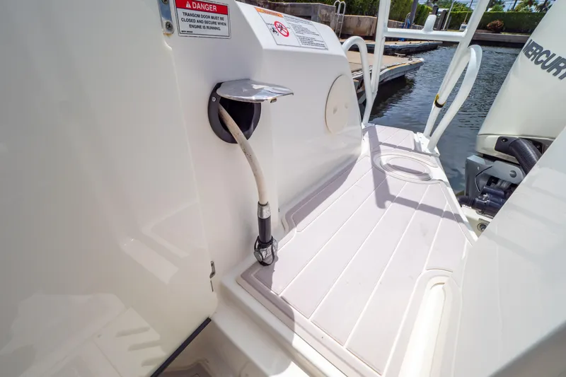 Slide: The Image of 2019 Boston Whaler 270 Vantage boat deck with safety warning and engine details. - 30