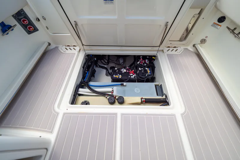 Slide: The Image of 2019 Boston Whaler 270 Vantage boat storage compartment with visible wiring and equipment. - 33