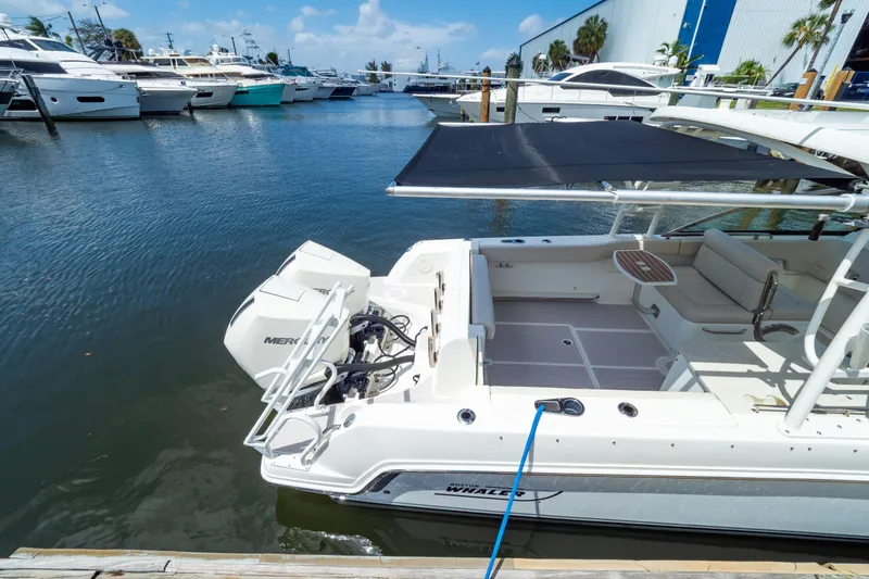 Slide: The Image of 2019 Boston Whaler 270 Vantage docked at marina with other boats. - 35