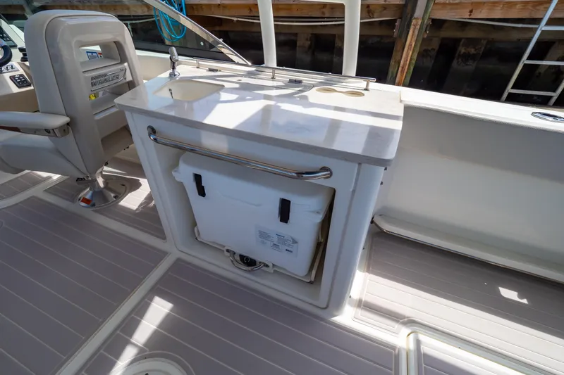 Slide: The Image of 2019 Boston Whaler 270 Vantage interior with seating and storage area. - 36