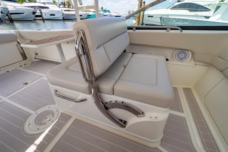 Slide: The Image of 2019 Boston Whaler 270 Vantage interior with cushioned seating and sleek design. - 40