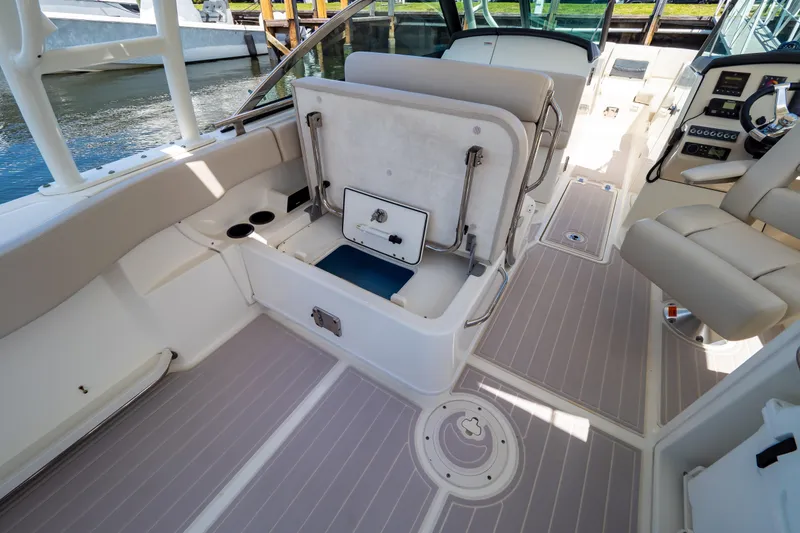 Slide: The Image of 2019 Boston Whaler 270 Vantage interior with seating and storage compartments. - 45
