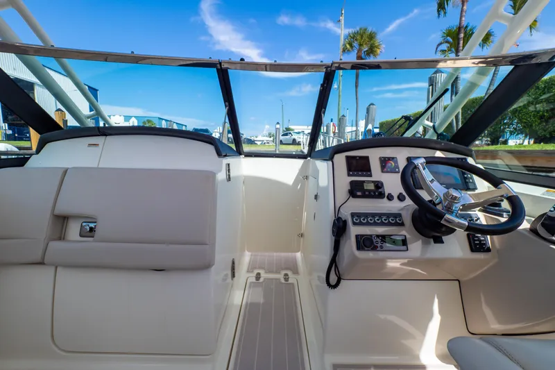Slide: The Image of 2019 Boston Whaler 270 Vantage cockpit with steering wheel and control panel. - 47