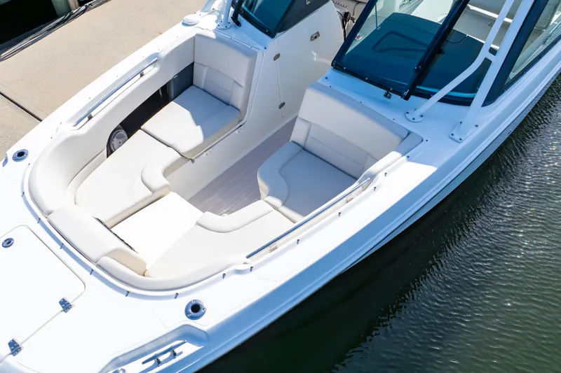 Slide: The Image of 2019 Boston Whaler 270 Vantage boat with spacious seating, docked on calm water. - 5