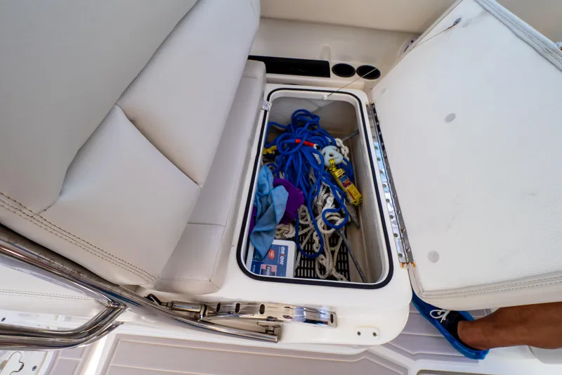 Slide: The Image of 2019 Boston Whaler 270 Vantage storage compartment with ropes and accessories. - 57