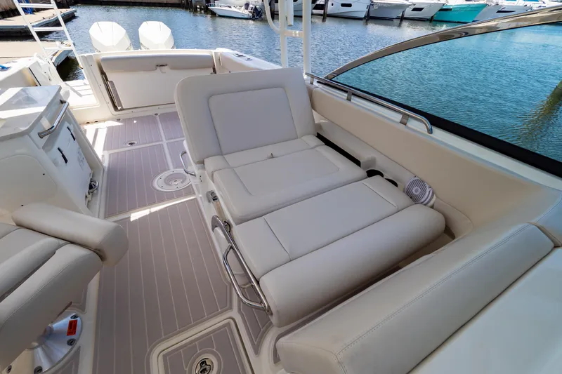 Slide: The Image of 2019 Boston Whaler 270 Vantage interior with luxurious seating and waterfront view. - 6