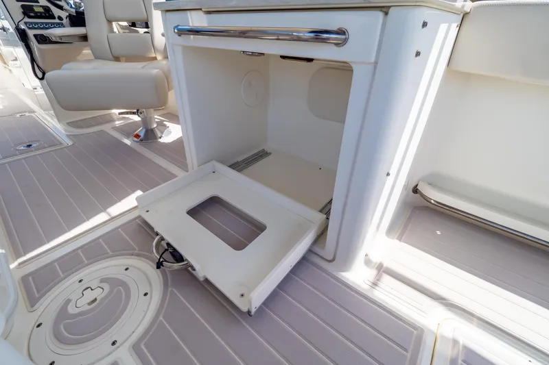 Slide: The Image of 2019 Boston Whaler 270 Vantage interior with open storage compartment and seating. - 60