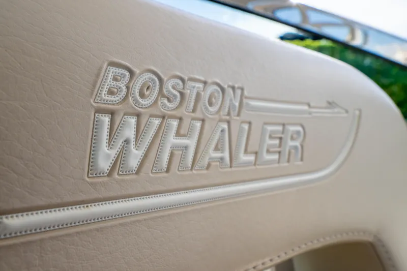 Slide: The Image of Close-up of embossed Boston Whaler logo on 2019 270 Vantage boat seat. - 63