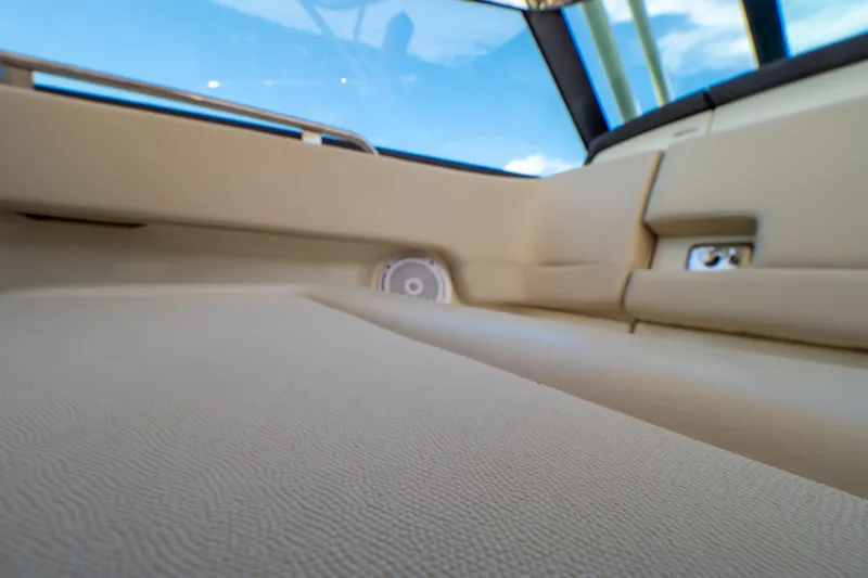 Slide: The Image of Interior view of 2019 Boston Whaler 270 Vantage boat, featuring beige upholstery and speaker. - 64
