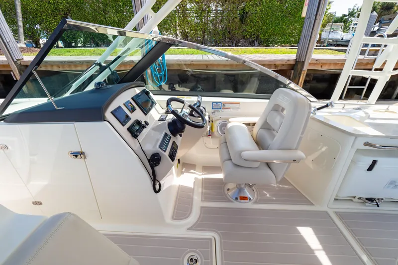 Slide: The Image of 2019 Boston Whaler 270 Vantage helm with steering wheel and control panel. - 66