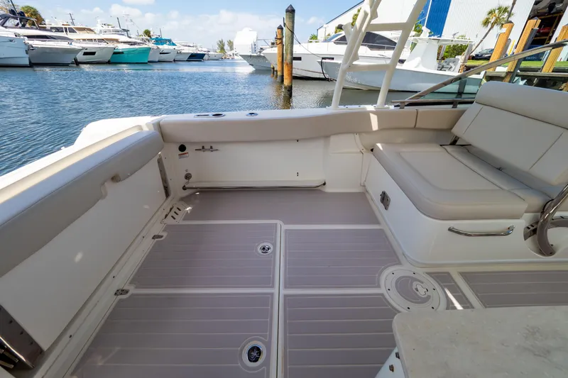 Slide: The Image of 2019 Boston Whaler 270 Vantage boat interior with seating, docked at marina. - 7