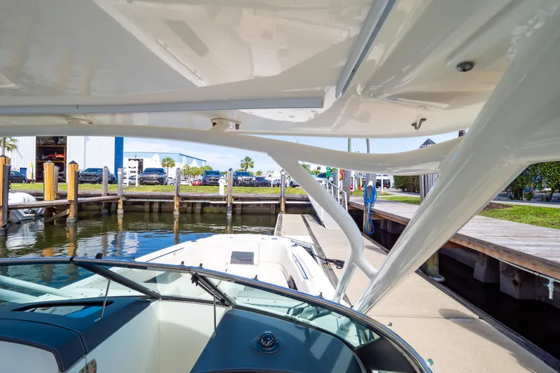 Slide: The Image of 2019 Boston Whaler 270 Vantage docked at marina, showcasing sleek design and waterfront setting. - 74