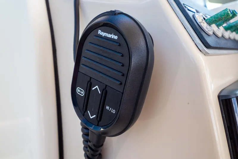 Slide: The Image of Raymarine radio microphone on 2019 Boston Whaler 270 Vantage boat dashboard. - 76