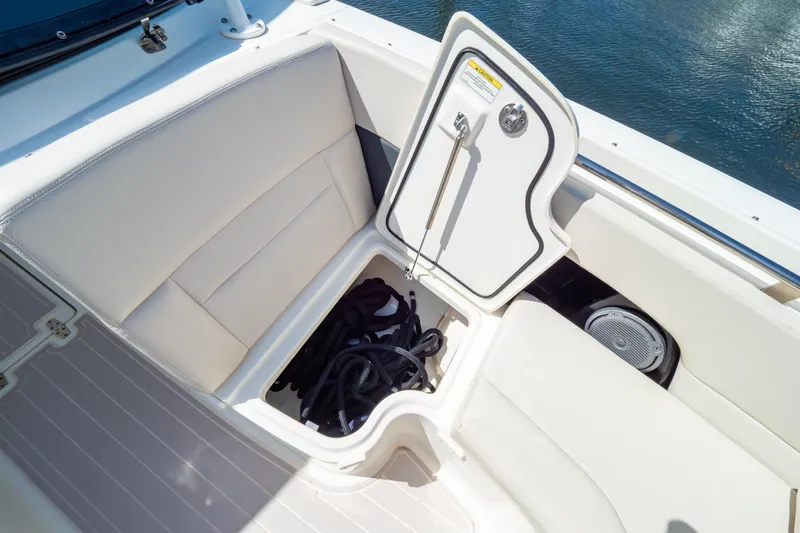 Slide: The Image of 2019 Boston Whaler 270 Vantage boat storage compartment with open hatch and coiled rope. - 87