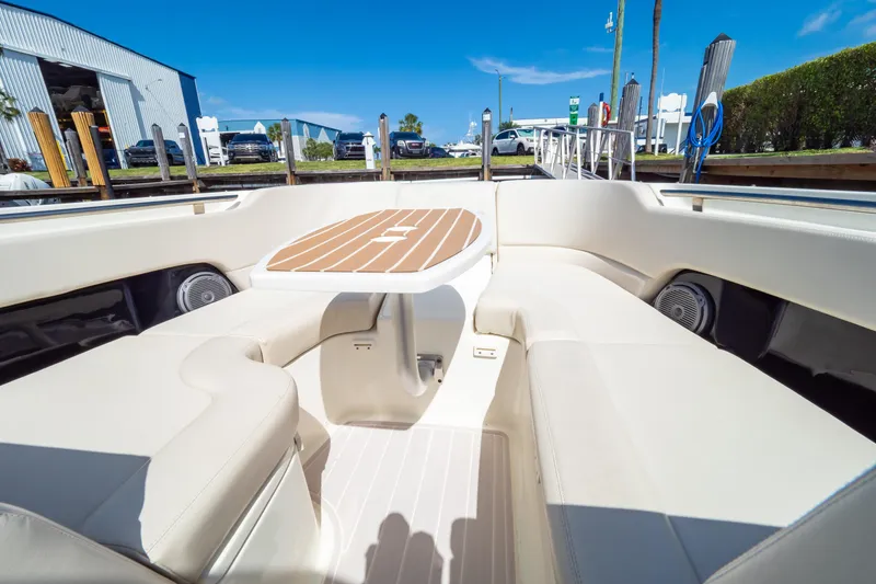 Slide: The Image of 2019 Boston Whaler 270 Vantage boat interior with cushioned seating and table. - 89