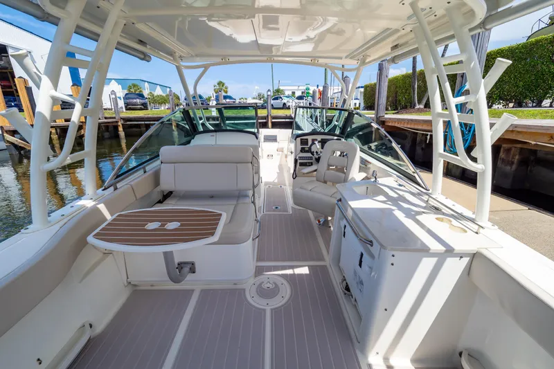 Slide: The Image of 2019 Boston Whaler 270 Vantage boat interior with seating, helm, and table. - 9