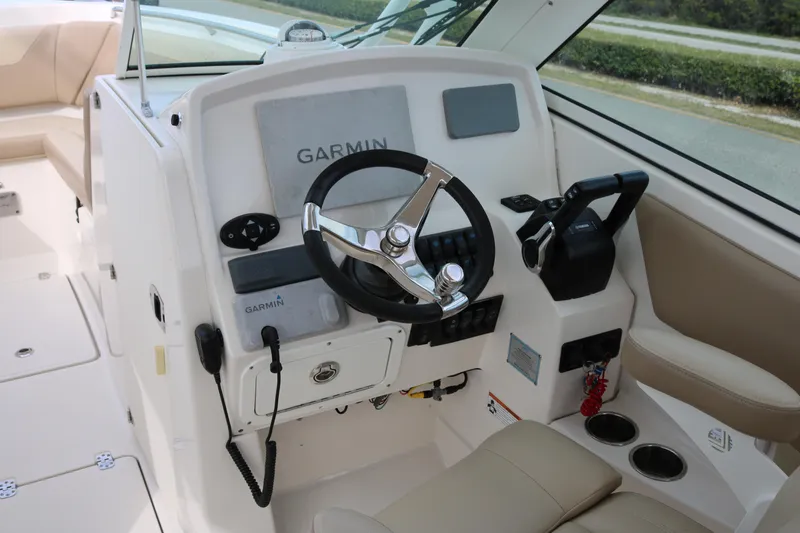 Slide: The Image of 2020 Sailfish 275 DC boat helm with Garmin navigation system and steering wheel. - 10