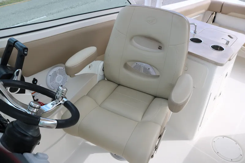 Slide: The Image of Captain's chair and helm of 2020 Sailfish 275 DC boat interior. - 11