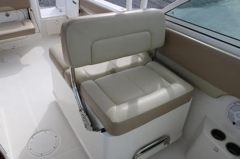 Slide: The Image of 2020 Sailfish 275 DC boat interior with beige seating and cup holders. - 18