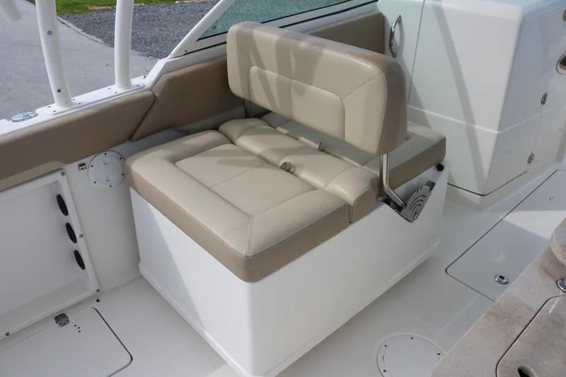 Slide: The Image of 2020 Sailfish 275 DC boat interior with beige cushioned seating. - 19