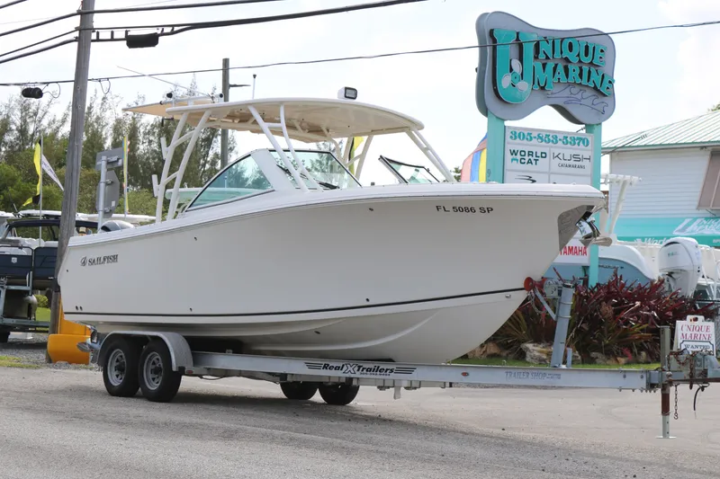 Slide: The Image of 2020 Sailfish 275 DC boat on trailer at Unique Marine dealership. - 3