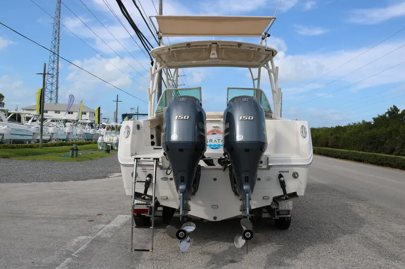 Slide: The Image of 2020 Sailfish 275 DC boat with dual Yamaha 150 engines, parked on a sunny day. - 5