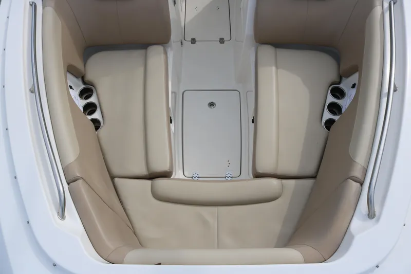 Slide: The Image of 2020 Sailfish 275 DC boat interior with beige seating and cup holders. - 9