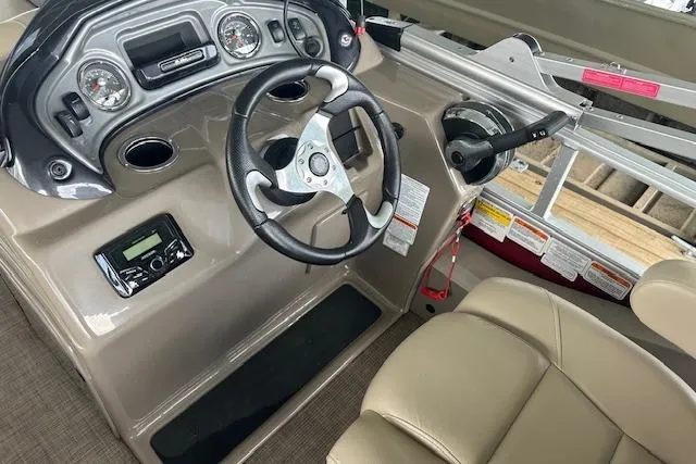 Slide: The Image of Steering console of 2022 Sun Tracker Fishin' Barge 24 DLX with gauges and controls. - 14