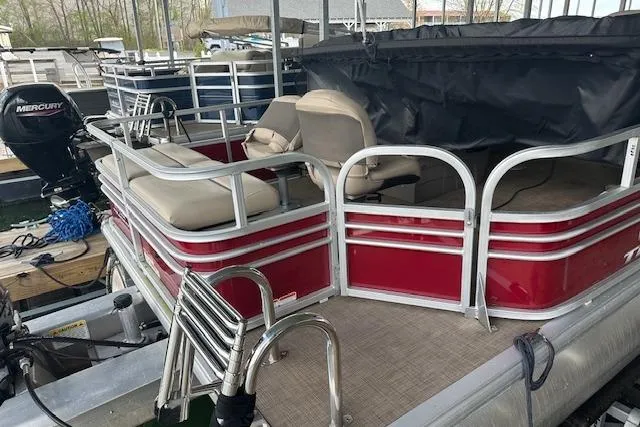 Slide: The Image of 2022 Sun Tracker Fishin' Barge 24 DLX pontoon boat with red exterior and seating. - 2