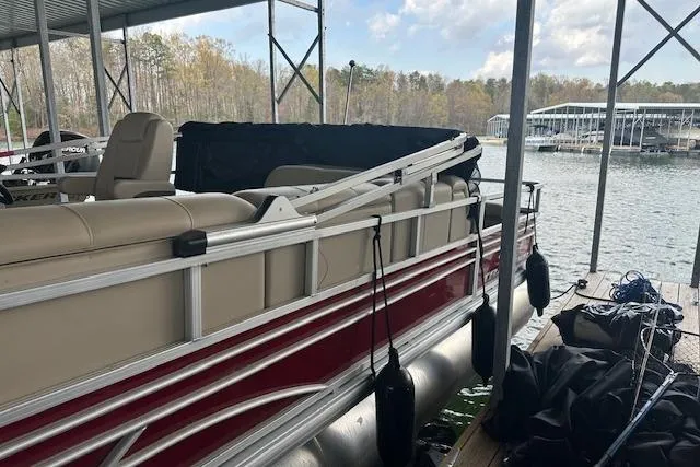 Slide: The Image of 2022 Sun Tracker Fishin' Barge 24 DLX docked at a lakeside marina. - 4
