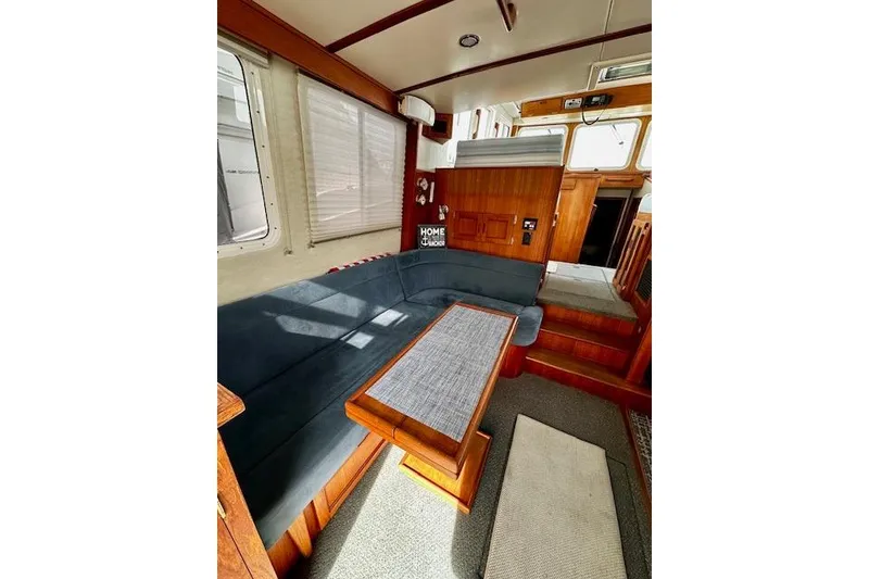 Slide: The Image of Interior of 2006 Nordic Tug 37 with cozy seating and wooden accents. - 11