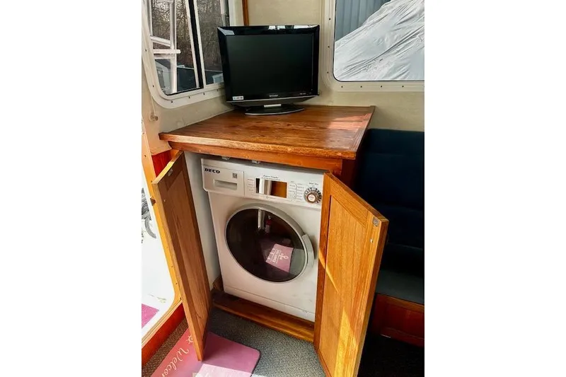 Slide: The Image of Laundry area with TV on Nordic Tug 37, 2006 model. - 12