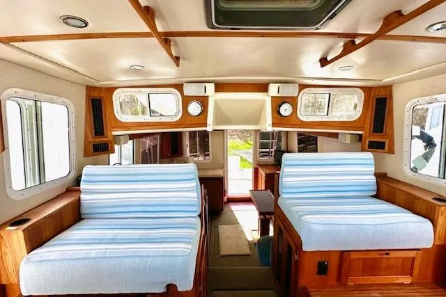 Slide: The Image of Interior of a 2006 Nordic Tug 37 with striped seating and wooden accents. - 16