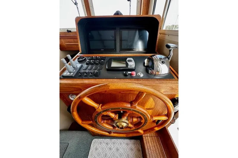 Slide: The Image of Helm of 2006 Nordic Tug 37 with wooden wheel and navigation controls. - 20