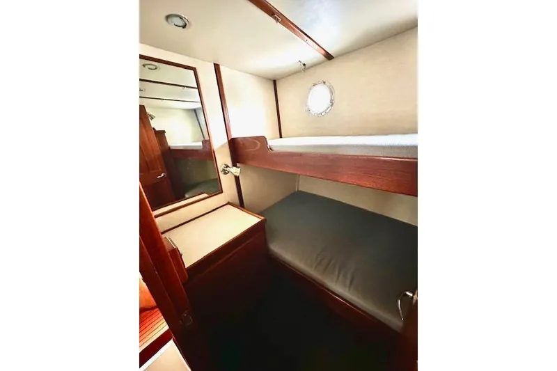 Slide: The Image of Cozy cabin with bunk beds in a 2006 Nordic Tug 37 boat. - 21