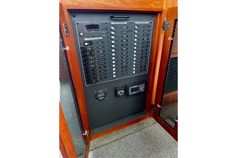 Slide: The Image of Electrical panel inside a 2006 Nordic Tug 37 boat, featuring switches and controls. - 22