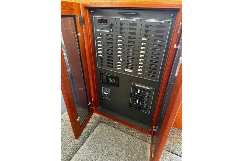 Slide: The Image of Electrical panel inside a 2006 Nordic Tug 37 boat, featuring switches and controls. - 23