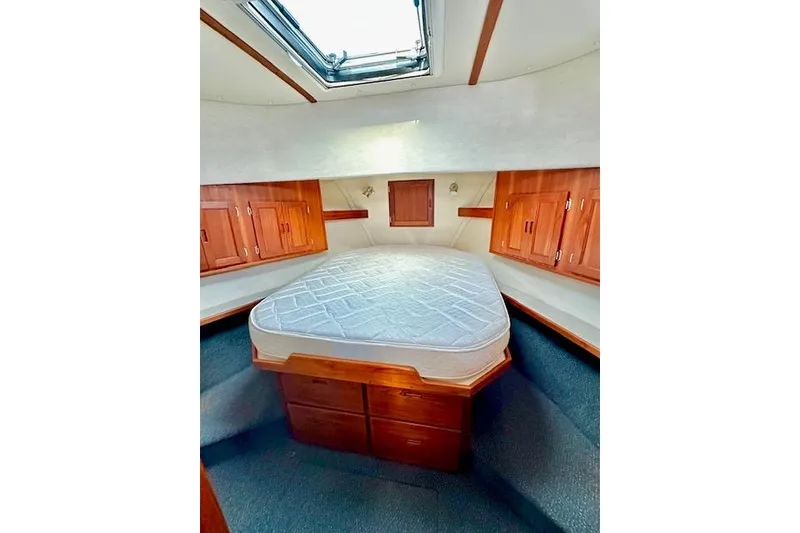 Slide: The Image of Cozy cabin interior of 2006 Nordic Tug 37 with wooden cabinetry and skylight. - 26