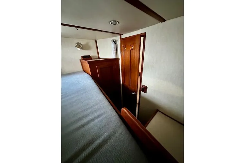 Slide: The Image of Interior of 2006 Nordic Tug 37, featuring wooden door and cozy cabin space. - 27