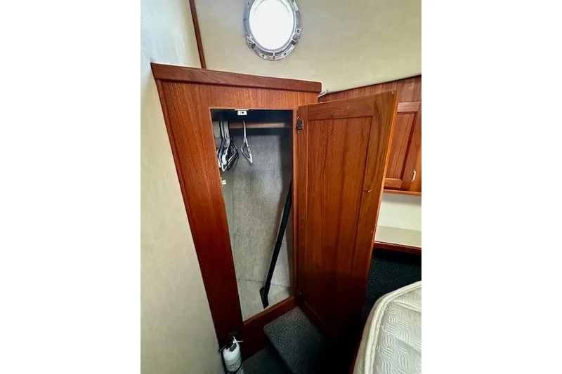 Slide: The Image of Wooden closet interior on a 2006 Nordic Tug 37 boat. - 28